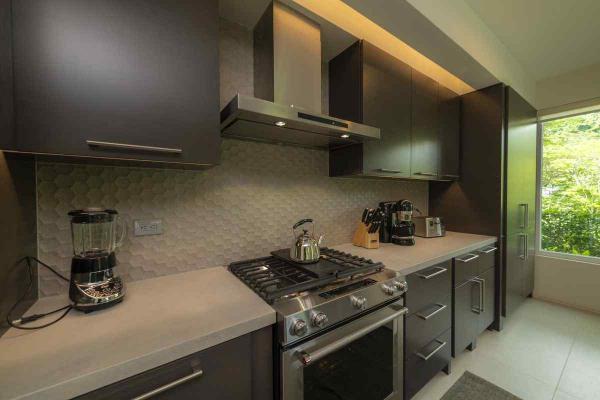 View of the fully equipped kitchen at Casa Forest in Los Suenos